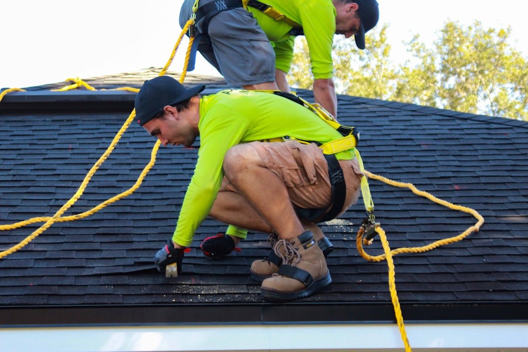 about-03 two-men-working-on-the-roof-of-a-house-rgknfjrpyo0